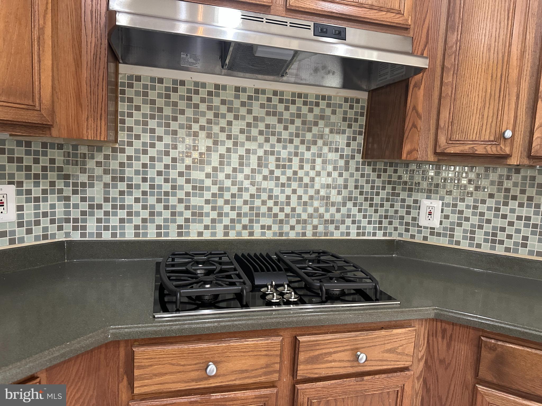8566 Brickshire Lane Manassas, VA 20112 - Photo 15 of 59 a close view of a stove a microwave and cabinets in the kitchen