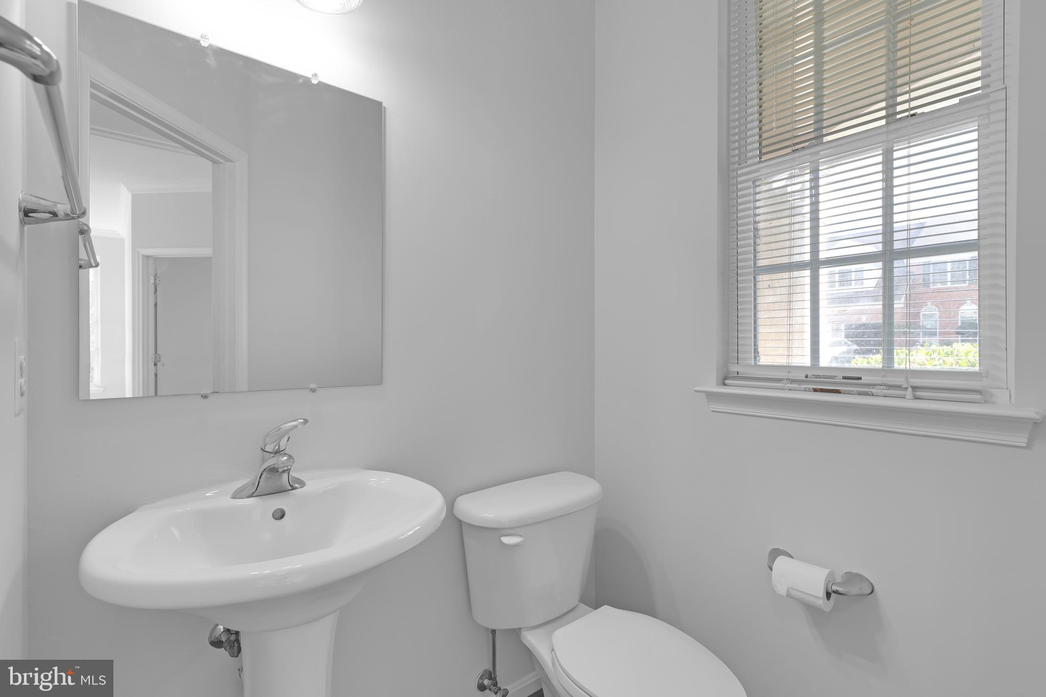 8566 Brickshire Lane Manassas, VA 20112 - Photo 17 of 59 a bathroom with a sink a toilet and a mirror