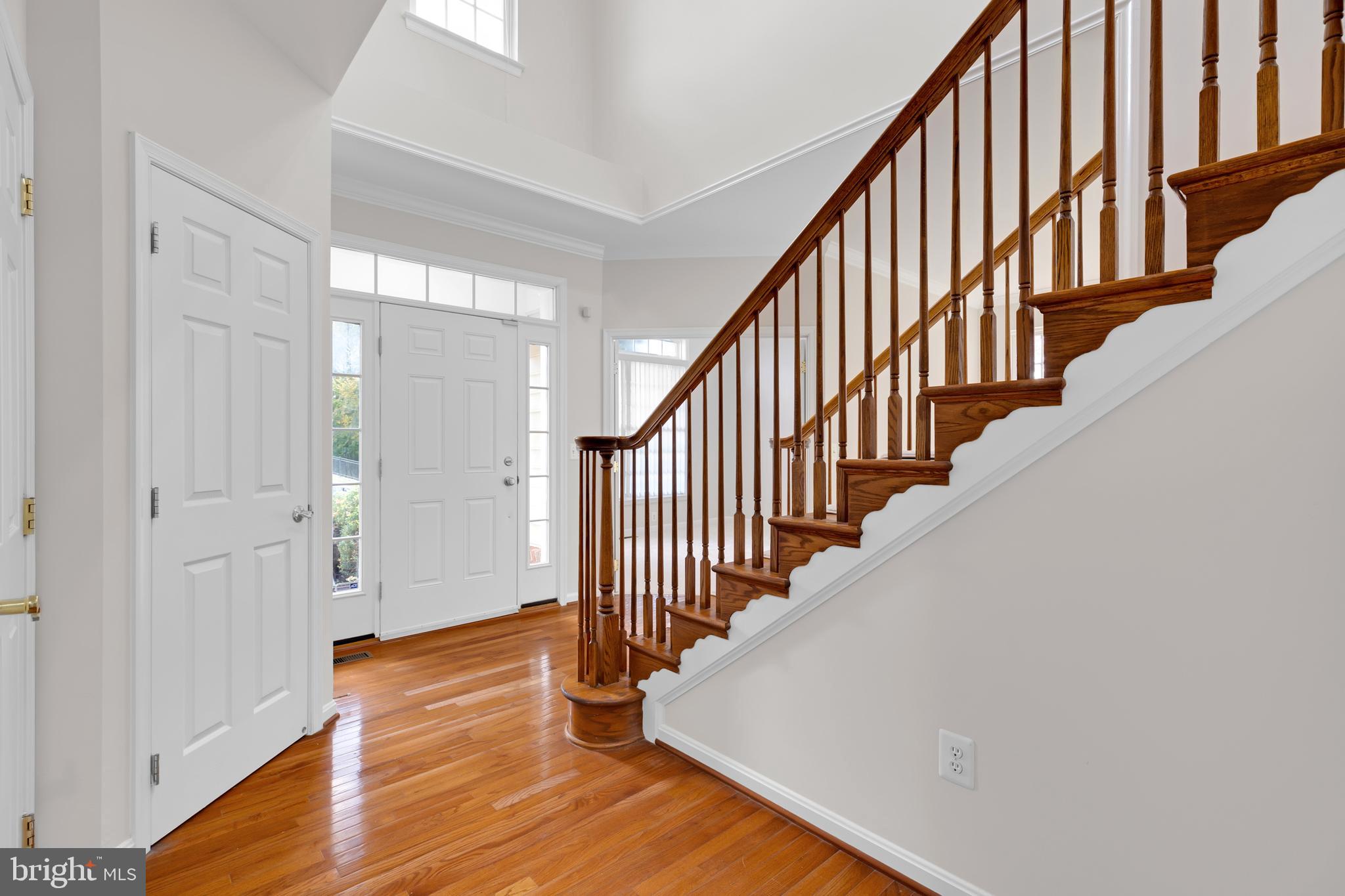 8566 Brickshire Lane Manassas, VA 20112 - Photo 20 of 59 a view of a hallway with wooden floor and staircase