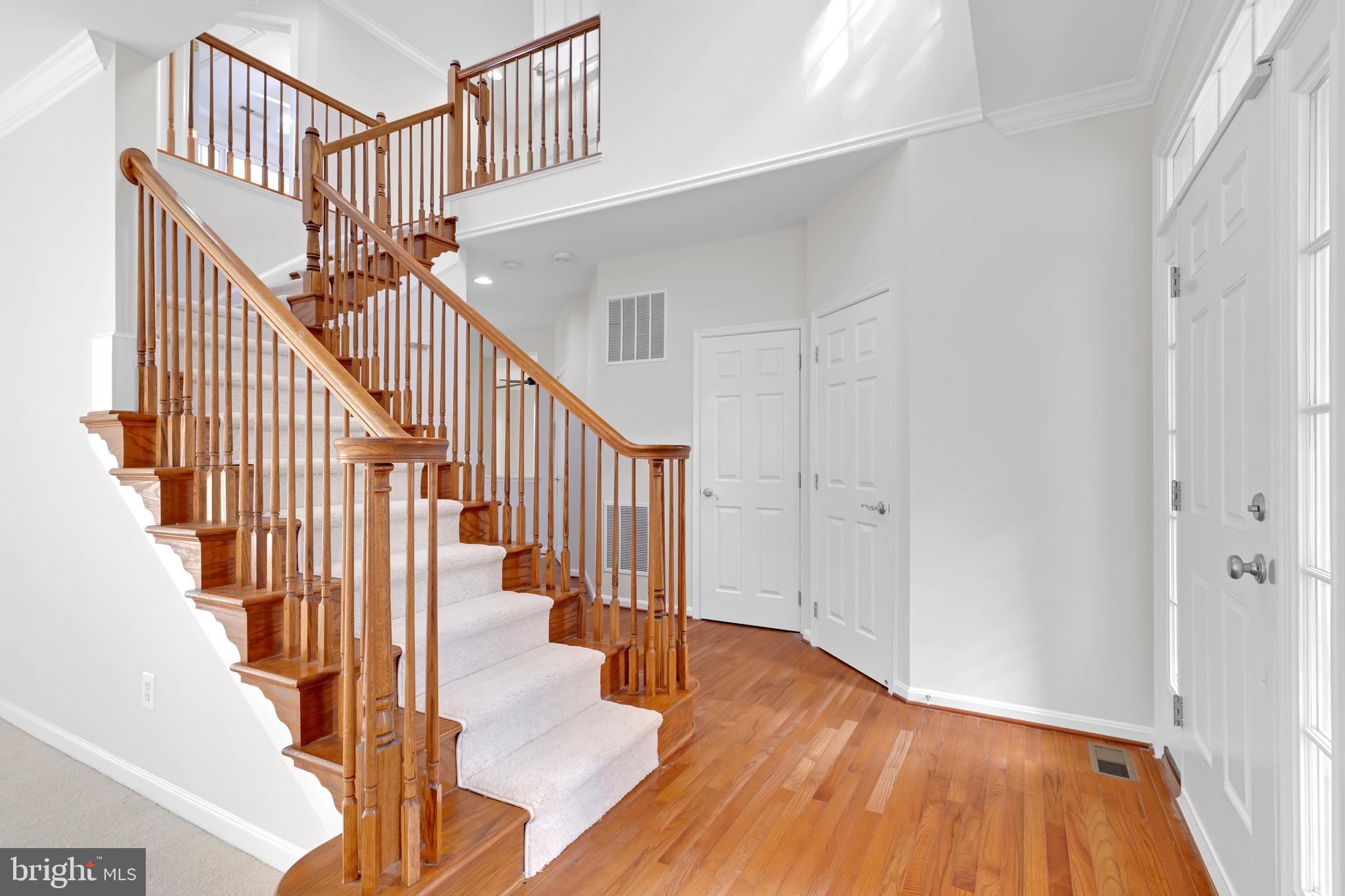 8566 Brickshire Lane Manassas, VA 20112 - Photo 21 of 59 a view of staircase with wooden floor and a chandelier