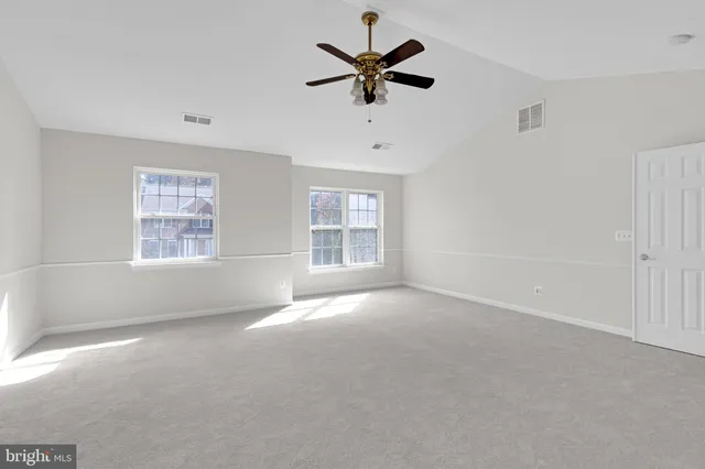a spacious bathroom with a tub a sink and mirror