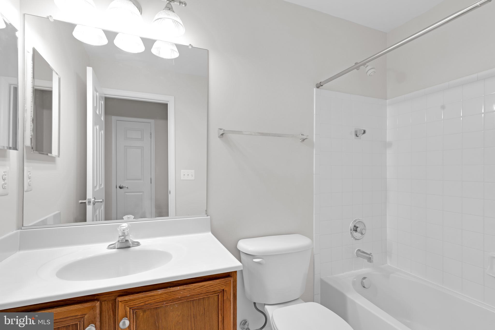 8566 Brickshire Lane Manassas, VA 20112 - Photo 41 of 59 a bathroom with a sink a toilet and a mirror