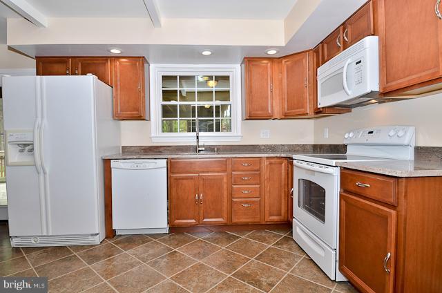 6902 Huntsman Boulevard Springfield, VA 22153 - Photo 2 of 27 a kitchen with stainless steel appliances granite countertop a refrigerator sink and cabinets