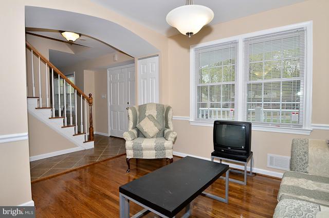 6902 Huntsman Boulevard Springfield, VA 22153 - Photo 14 of 27 a living room with furniture fireplace and a table