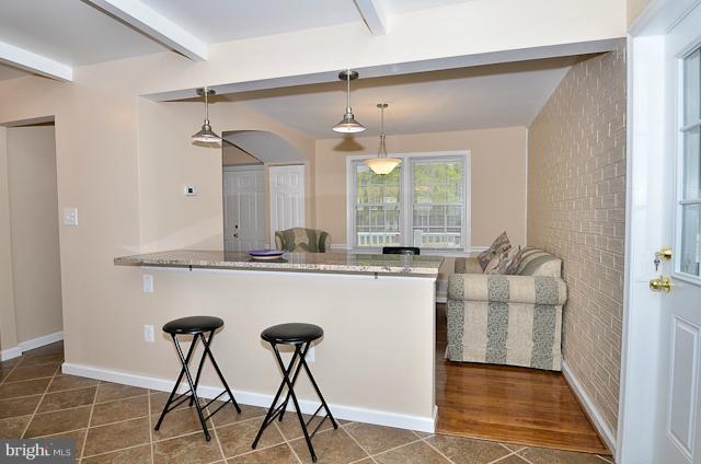 6902 Huntsman Boulevard Springfield, VA 22153 - Photo 18 of 27 a kitchen with kitchen island a counter top space a sink and cabinets