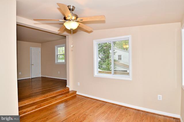 6902 Huntsman Boulevard Springfield, VA 22153 - Photo 20 of 27 a view of an empty room with window and chandelier fan
