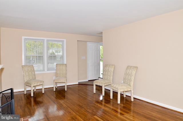 6902 Huntsman Boulevard Springfield, VA 22153 - Photo 22 of 27 a living room with furniture and a table