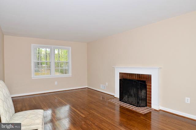 6902 Huntsman Boulevard Springfield, VA 22153 - Photo 24 of 27 a view of an empty room with wooden floor and a window