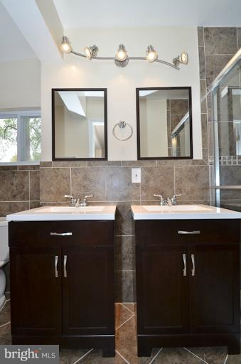 6902 Huntsman Boulevard Springfield, VA 22153 - Photo 4 of 27 a sink with granite countertop a sink and cabinets