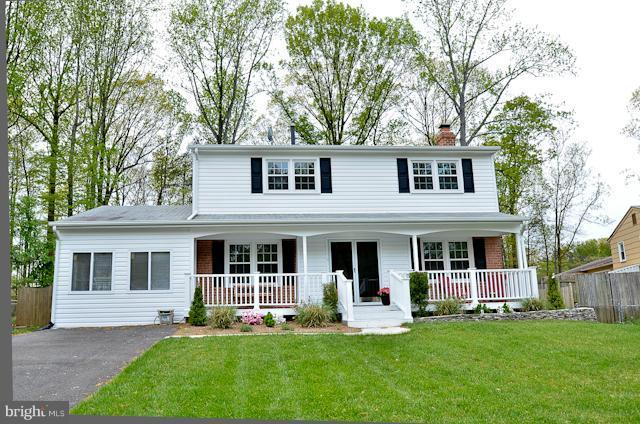 6902 Huntsman Boulevard Springfield, VA 22153 - Photo 5 of 27 front view of a house with a yard