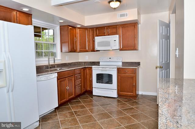 6902 Huntsman Boulevard Springfield, VA 22153 - Photo 6 of 27 a kitchen with a sink a stove and cabinets