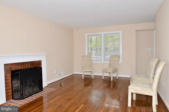 6902 Huntsman Boulevard Springfield, VA 22153 - Photo 8 of 27 a living room with furniture and a fireplace