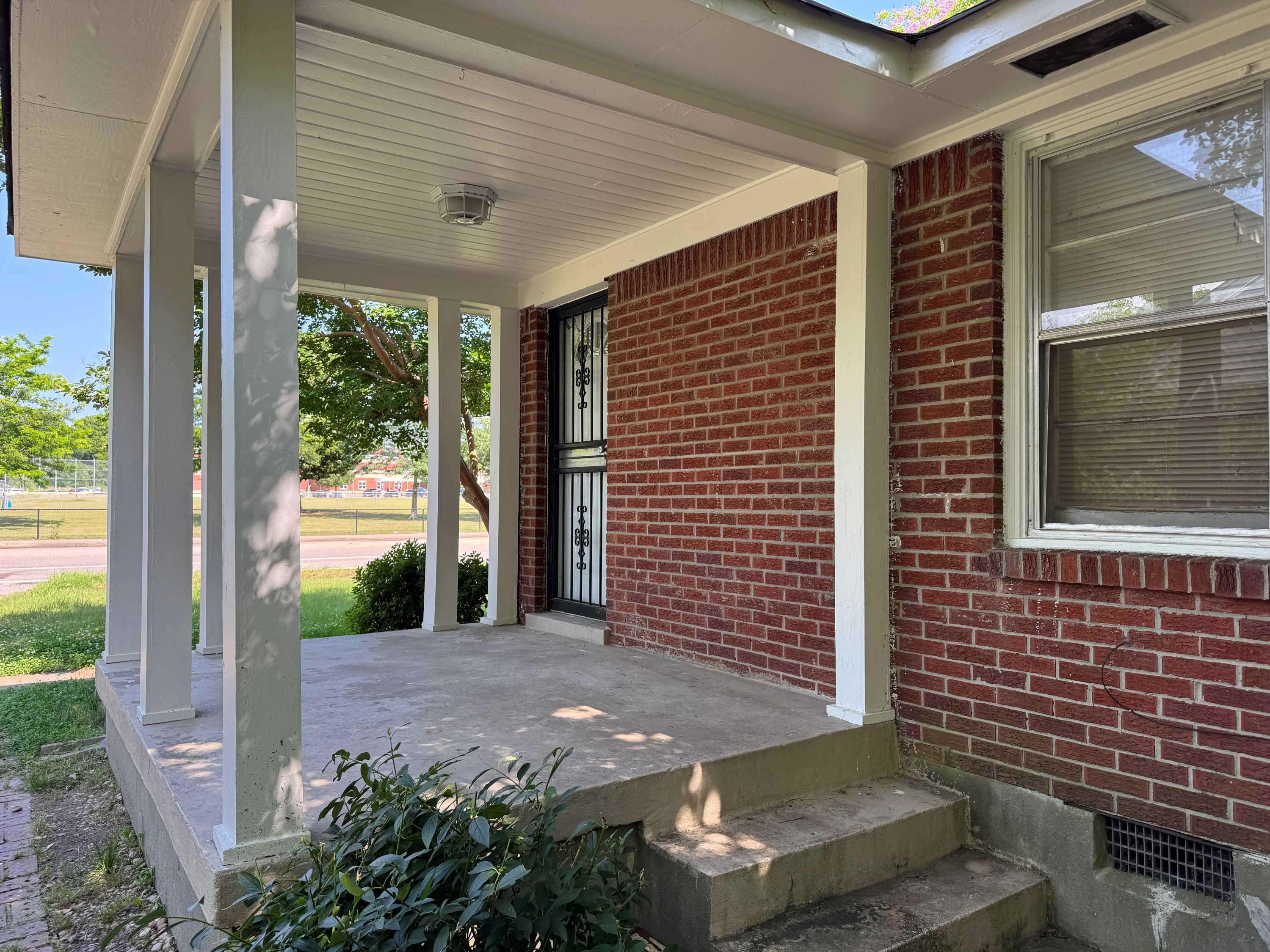 1343 Colonial Road Memphis, TN 38117 - Photo 3 of 33 a view of a patio with table and chairs and potted plants