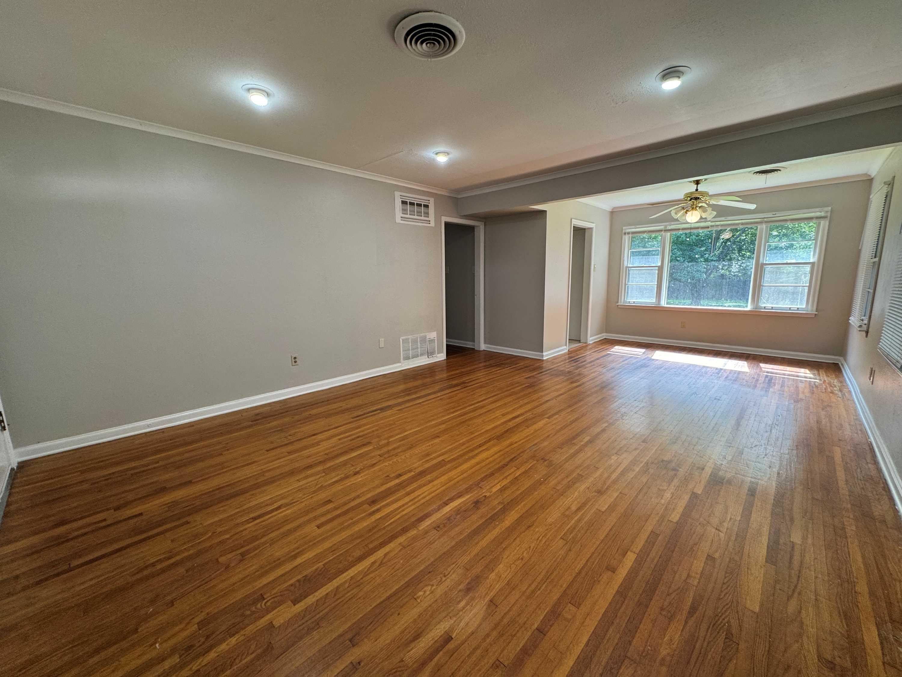 1343 Colonial Road Memphis, TN 38117 - Photo 5 of 33 an empty room with wooden floor and windows