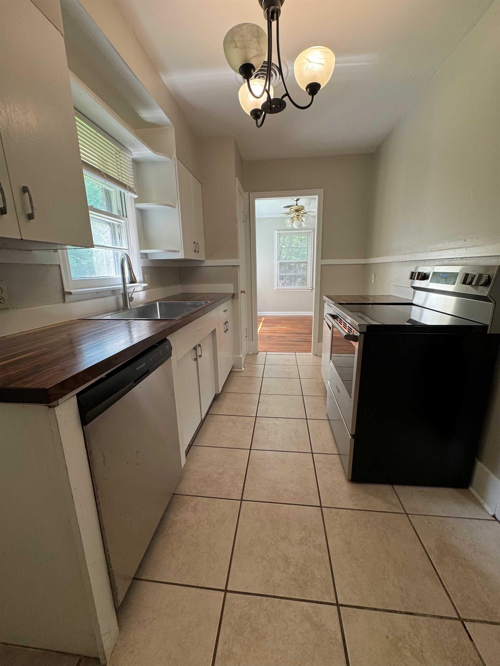 1343 Colonial Road Memphis, TN 38117 - Photo 8 of 33 a kitchen with stainless steel appliances granite countertop a sink and a stove