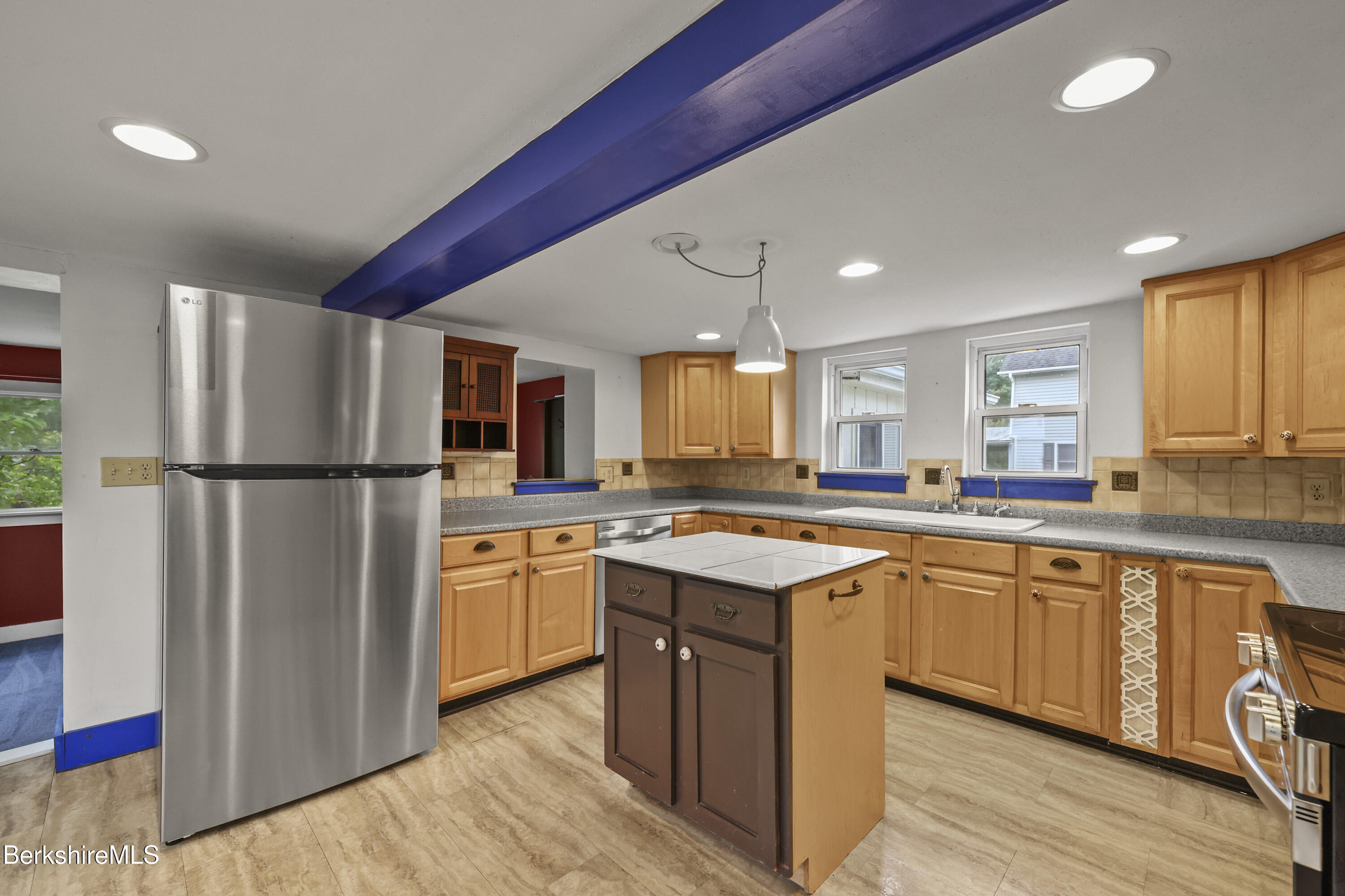 2801 State Road Richmond, MA 01254 - Photo 17 of 46 a kitchen with stainless steel appliances granite countertop a refrigerator a sink dishwasher a stove and white countertops with wooden floor