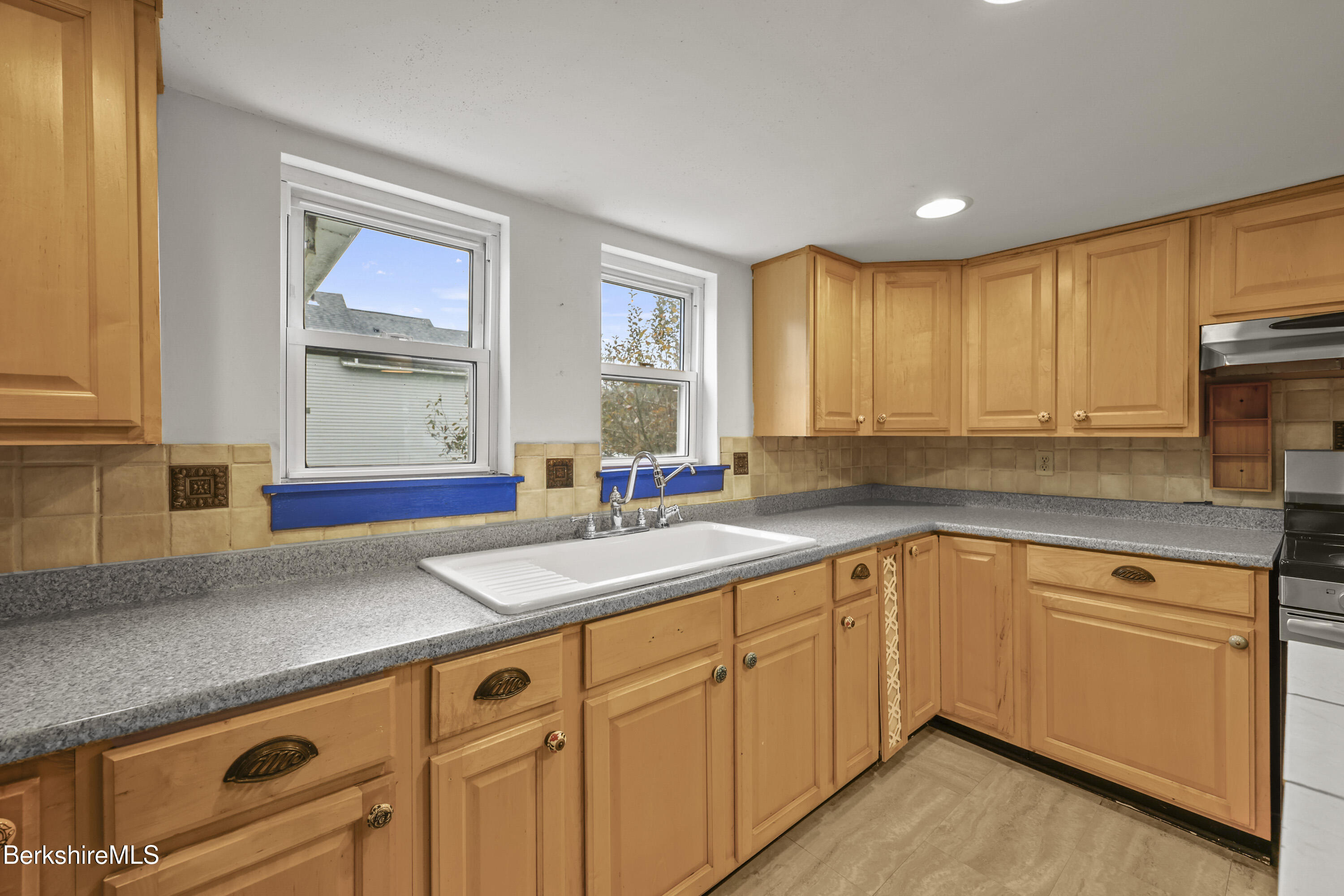 2801 State Road Richmond, MA 01254 - Photo 19 of 46 a kitchen with granite countertop white cabinets sink and window