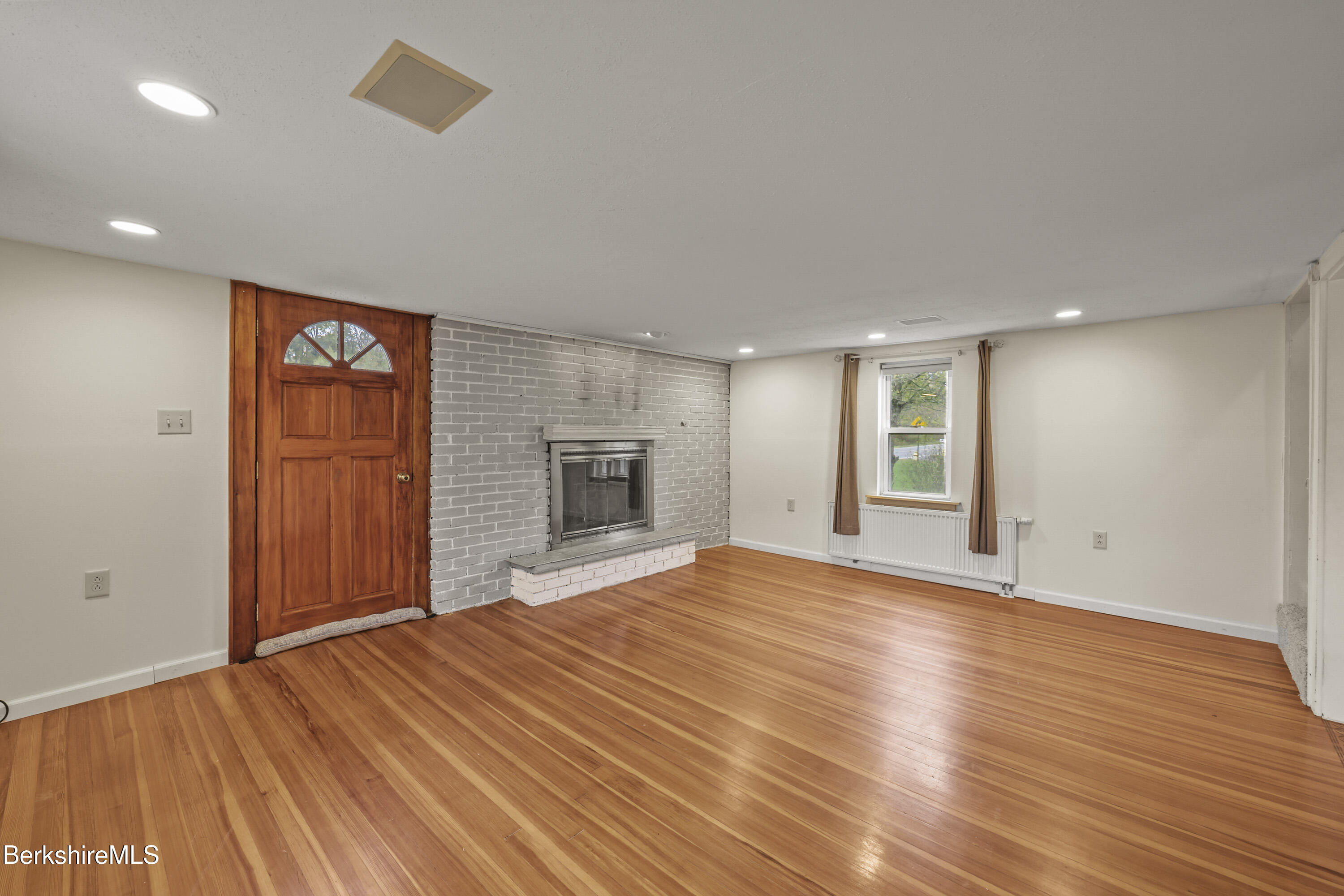 2801 State Road Richmond, MA 01254 - Photo 8 of 46 a view of empty room with wooden floor and fireplace