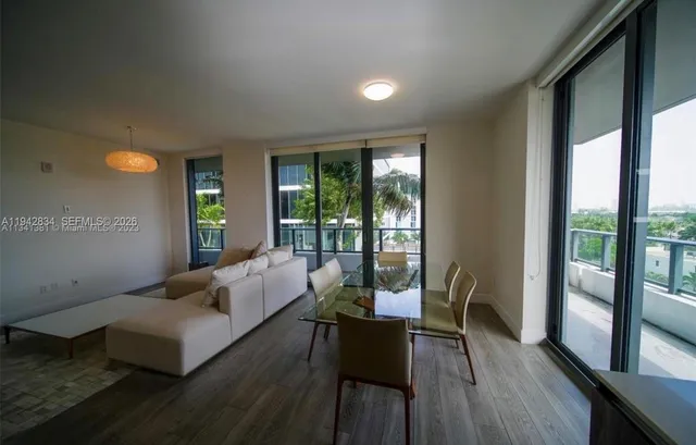 a living room with furniture and large windows