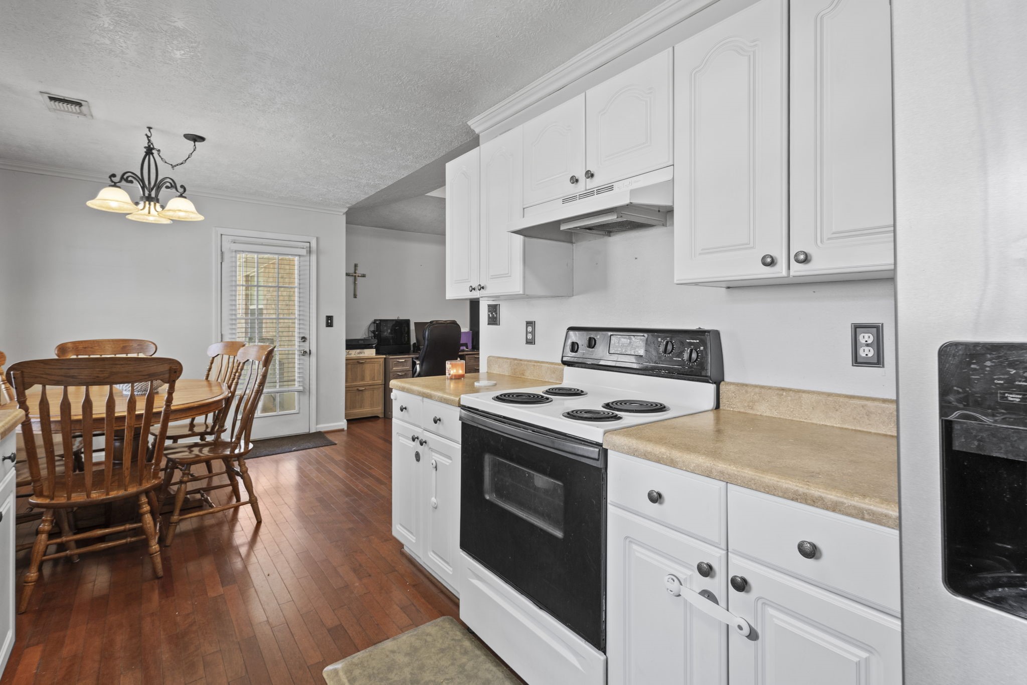 269 East Chance Cutoff Lumberton, TX 77657 - Photo 12 of 24 a kitchen with stainless steel appliances granite countertop a table chairs stove and white cabinets
