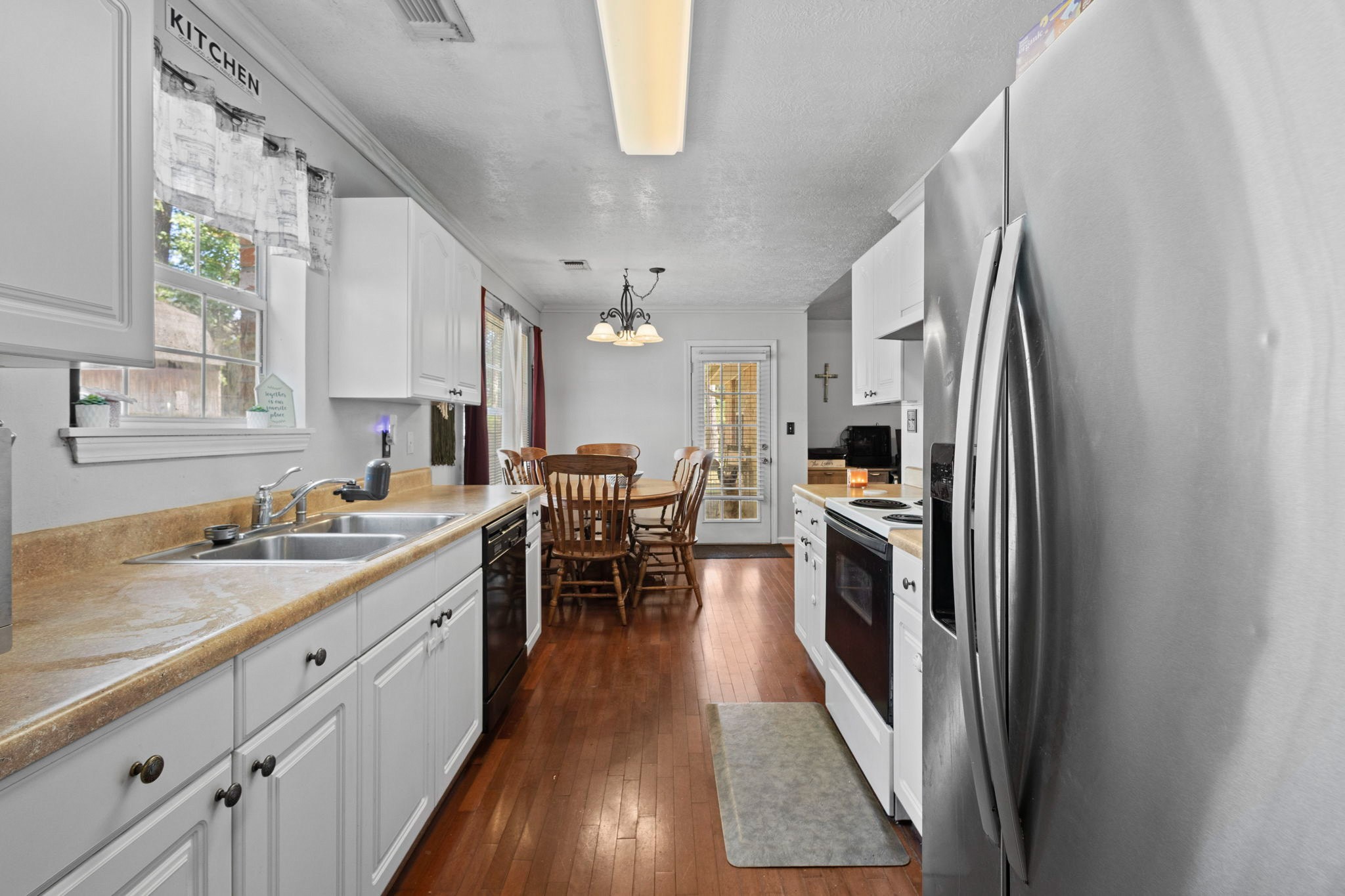 269 East Chance Cutoff Lumberton, TX 77657 - Photo 13 of 24 a kitchen with stainless steel appliances granite countertop a refrigerator a sink dishwasher a stove and white countertops with wooden floor