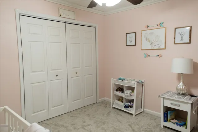 a room with a fireplace and a chandelier fan