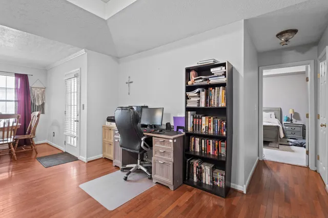 a view of a workspace with furniture and wooden floor