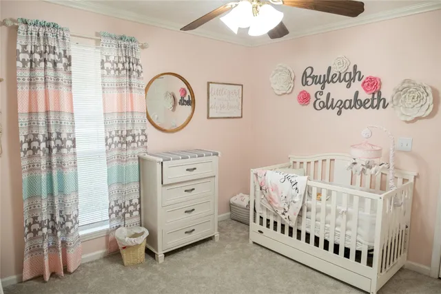 a bedroom with furniture and a large window