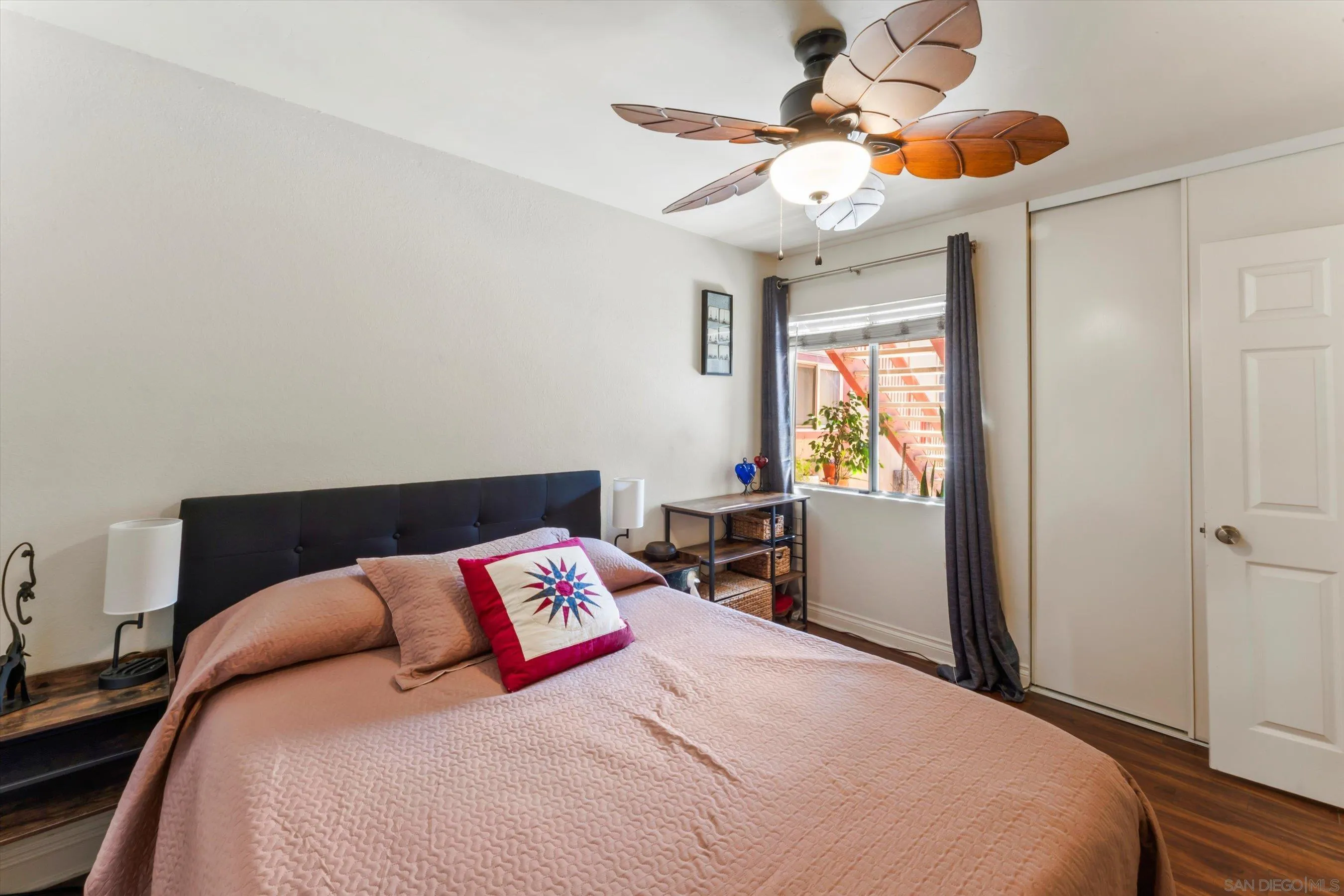 5483 Adobe Falls Road, Unit 7 San Diego, CA 92120 - Photo 13 of 20 a bedroom with a bed and a chandelier
