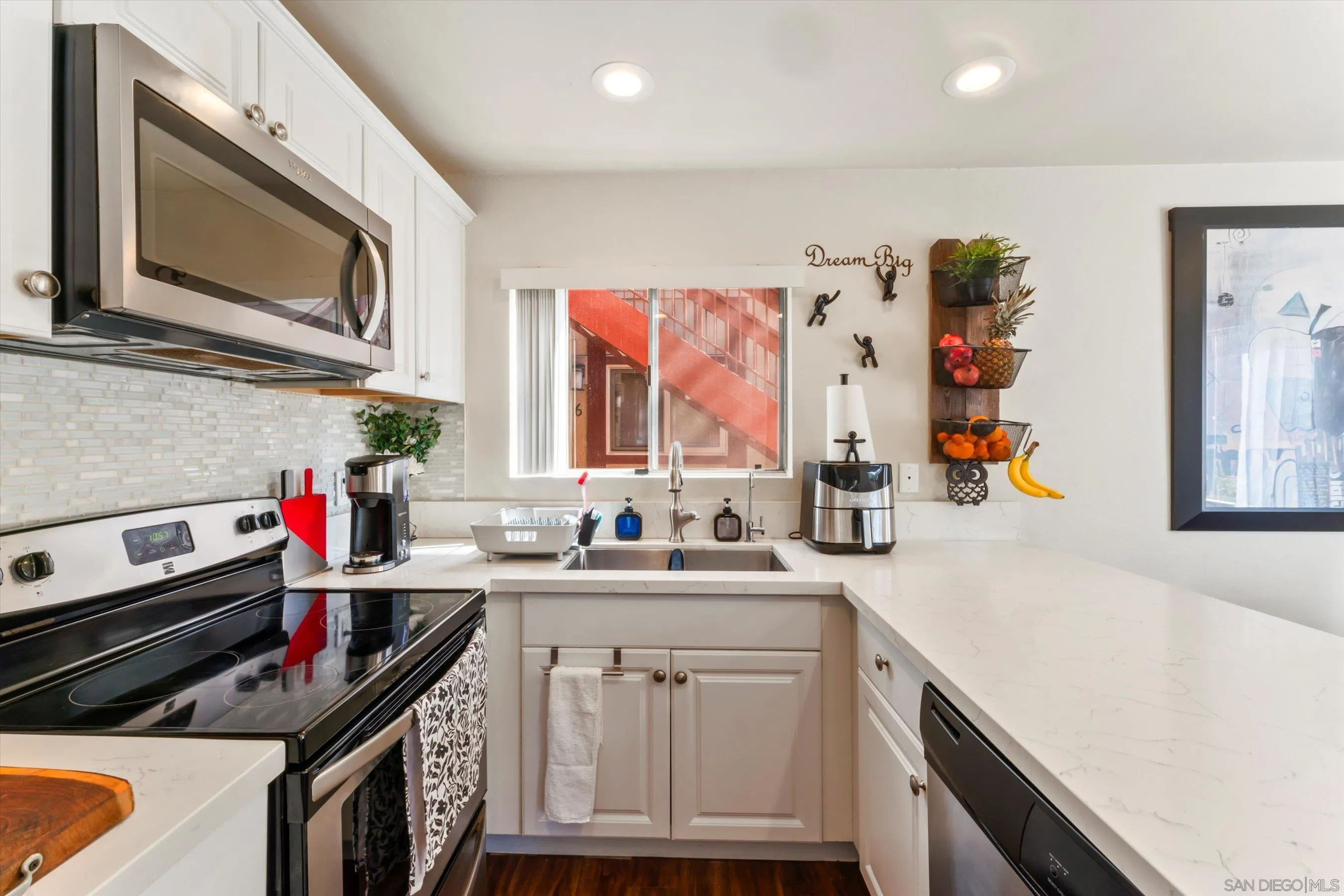 5483 Adobe Falls Road, Unit 7 San Diego, CA 92120 - Photo 6 of 20 a kitchen with a sink stove and microwave