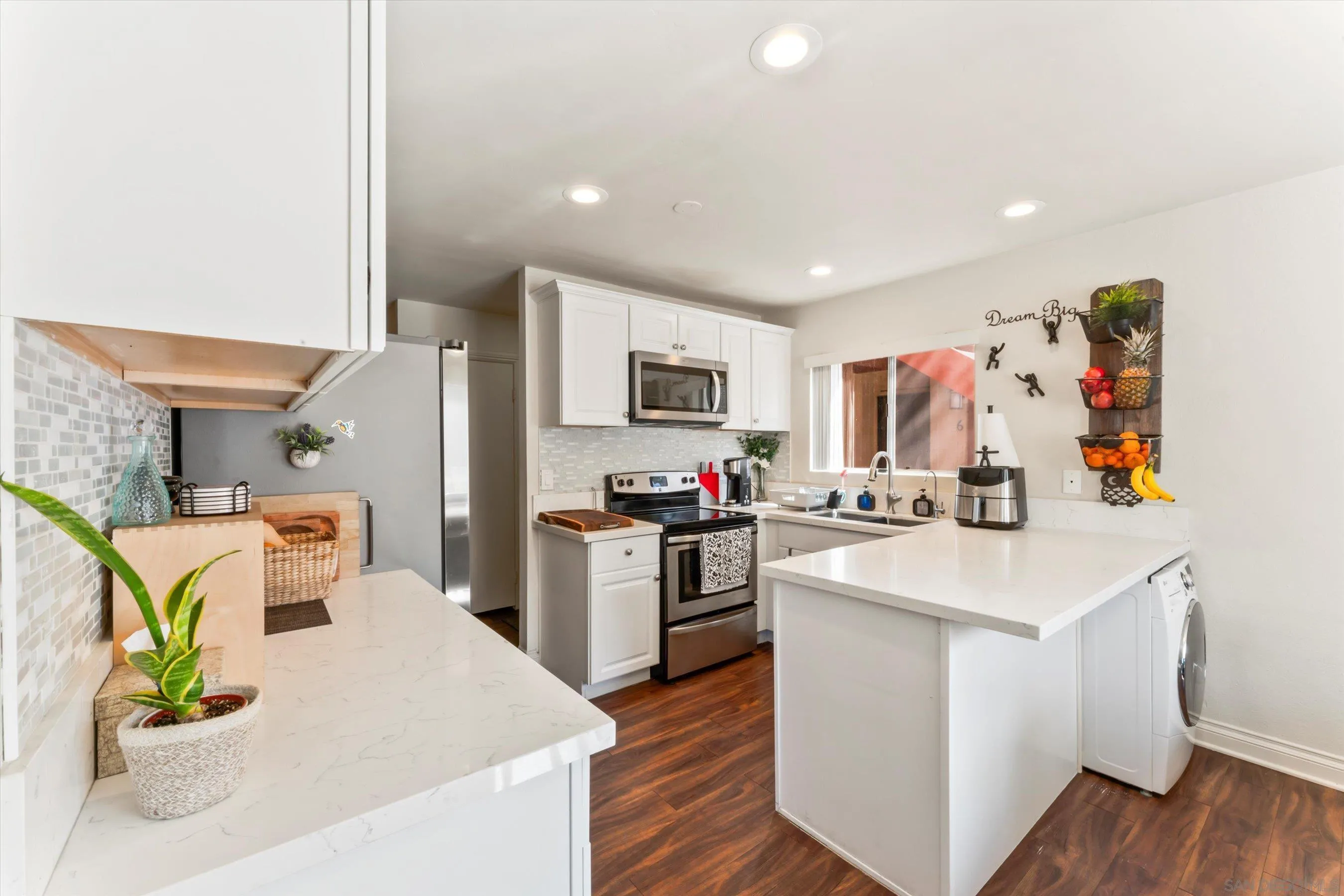 5483 Adobe Falls Road, Unit 7 San Diego, CA 92120 - Photo 7 of 20 a kitchen with stainless steel appliances kitchen island granite countertop a sink stove and refrigerator