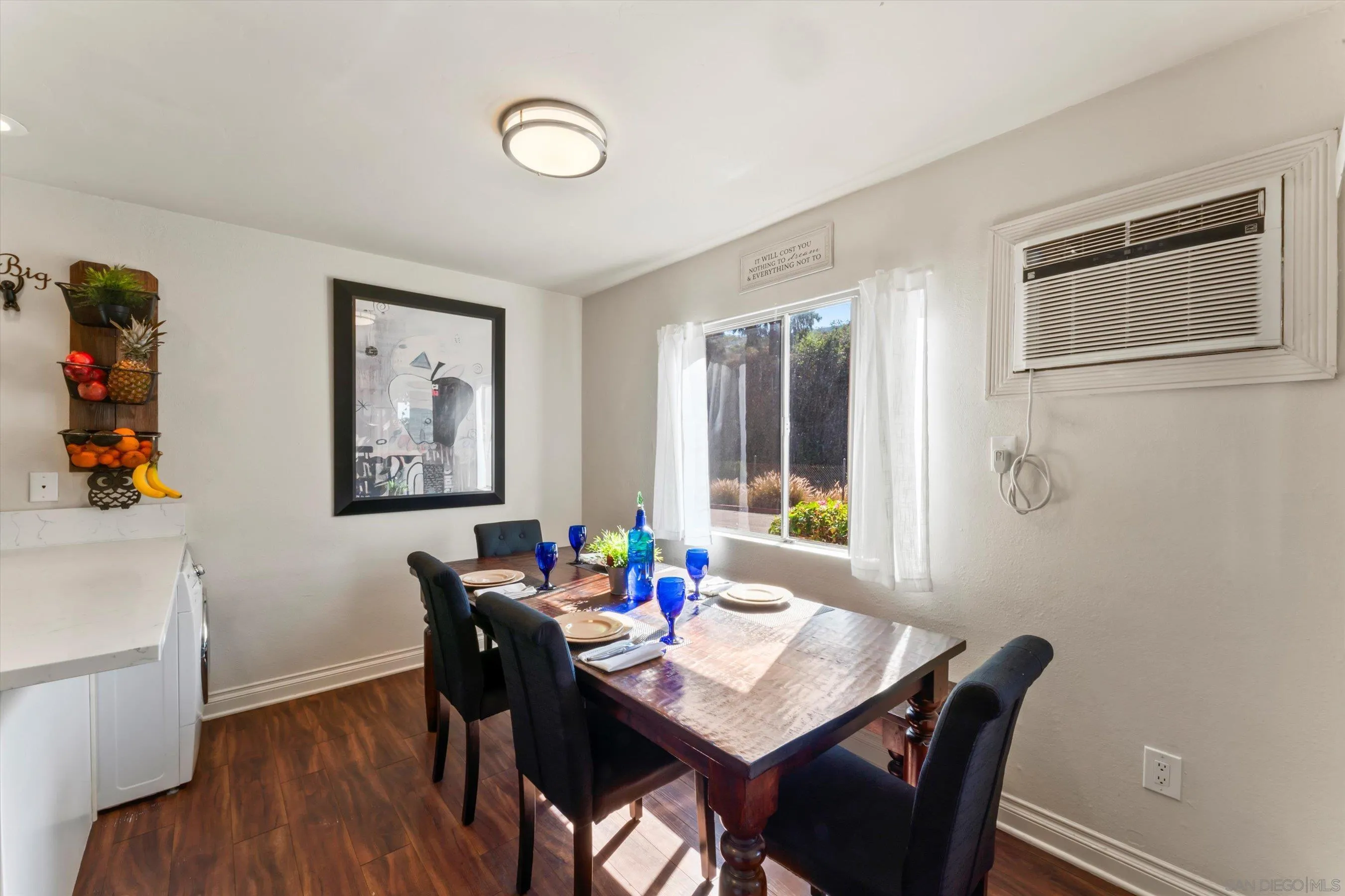 5483 Adobe Falls Road, Unit 7 San Diego, CA 92120 - Photo 8 of 20 a view of a dining room with furniture window and wooden floor