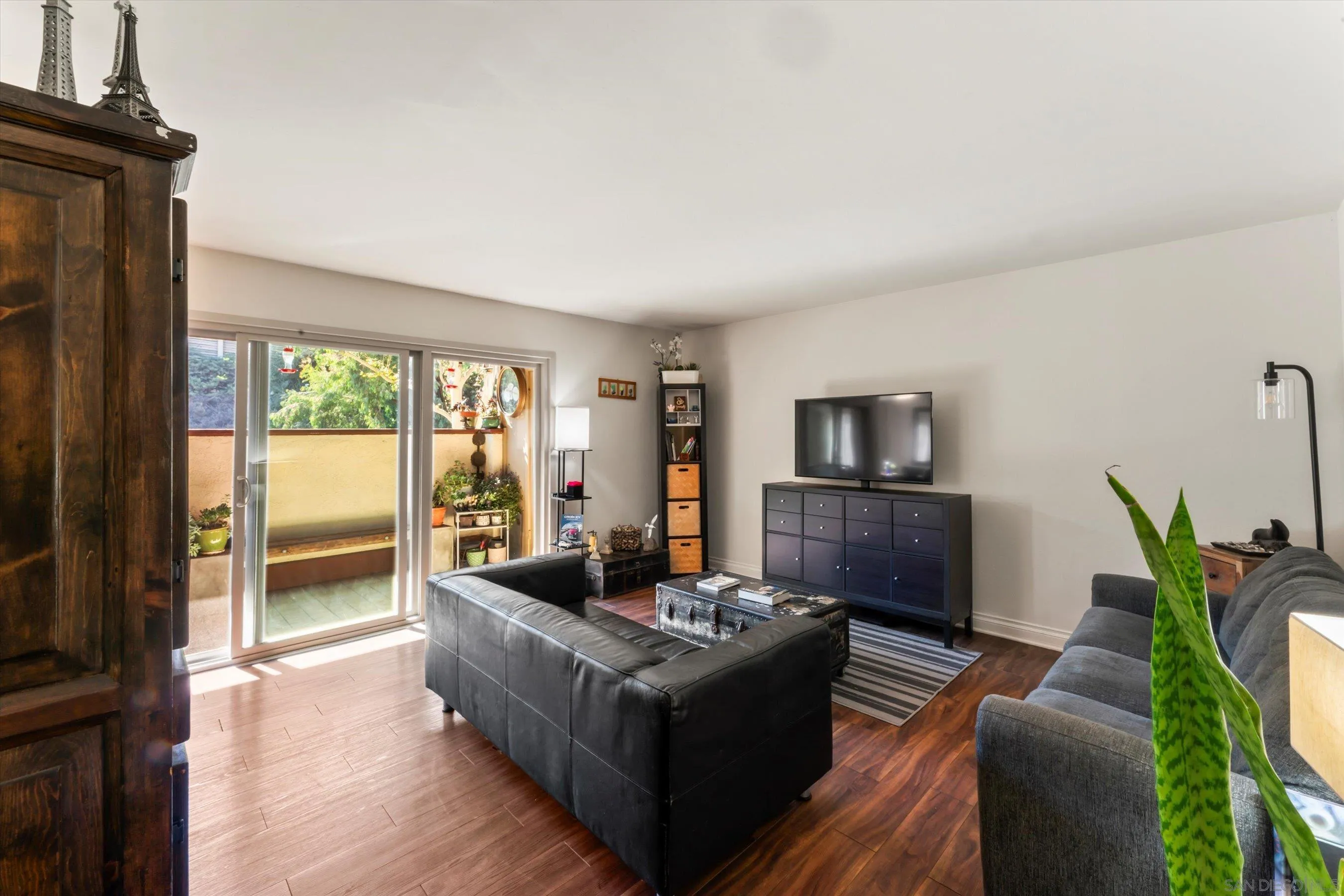 5483 Adobe Falls Road, Unit 7 San Diego, CA 92120 - Photo 10 of 20 a living room with furniture floor to ceiling window and wooden floor