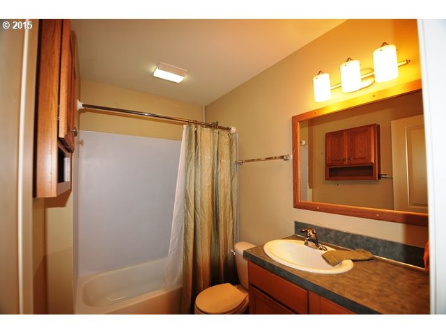 13320 Southwest Allen Boulevard, Unit 310 Beaverton, OR 97005 - Photo 13 of 18 a bathroom with a granite countertop sink and a mirror