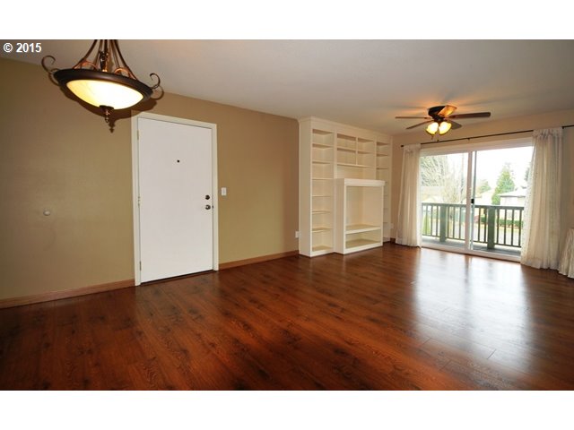13320 Southwest Allen Boulevard, Unit 310 Beaverton, OR 97005 - Photo 4 of 18 a view of an empty room with a window and wooden floor