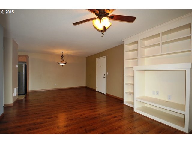 13320 Southwest Allen Boulevard, Unit 310 Beaverton, OR 97005 - Photo 6 of 18 a view of an empty room with a window and wooden floor
