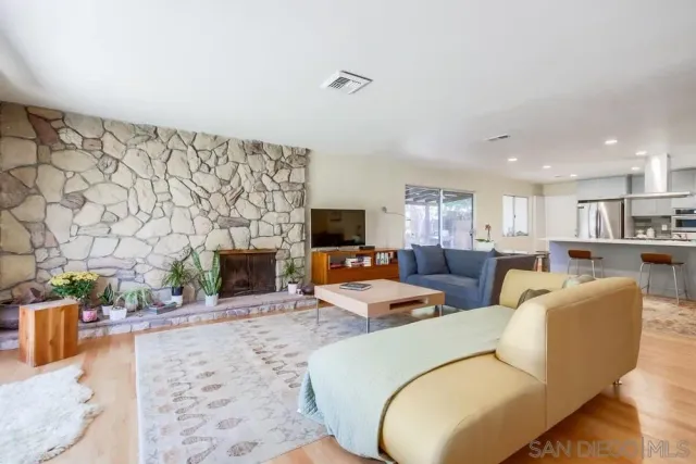 a living room with fireplace furniture and a fireplace