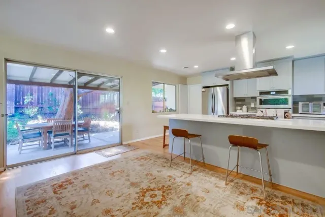 a kitchen with stainless steel appliances kitchen island granite countertop a sink and cabinets