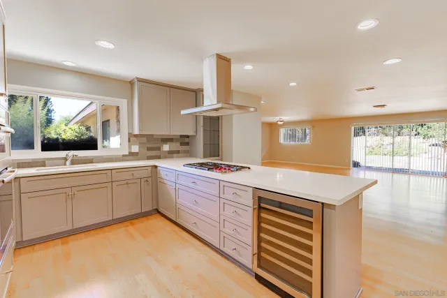 a kitchen with a stove a sink and a refrigerator