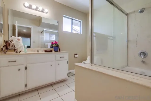 a bathroom with a sink vanity and a mirror