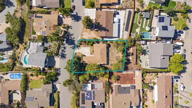 an aerial view of residential houses with outdoor space