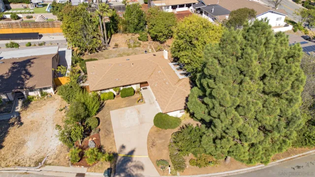 an aerial view of a house with a yard and trees