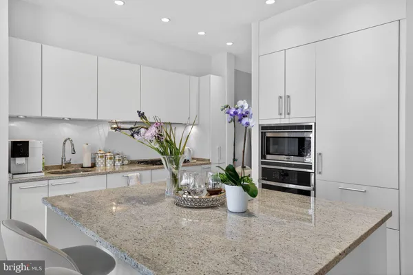 a kitchen with stainless steel appliances granite countertop a sink a stove and a granite counter tops