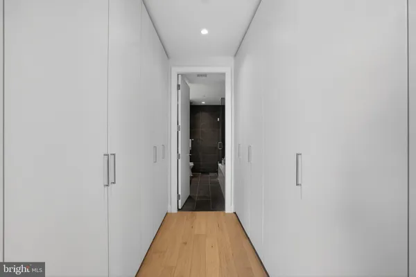 a view of a hallway with wooden floor