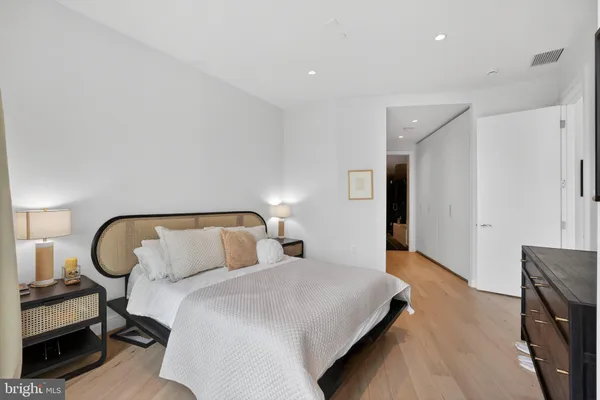 a bedroom with bed and a chair