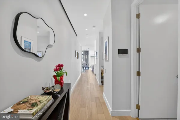 a view of entryway with furniture and wooden floor