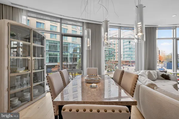 a view of a dining room with furniture large windows and wooden floor