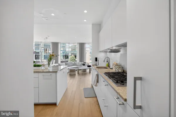a kitchen with a stove a sink and cabinets