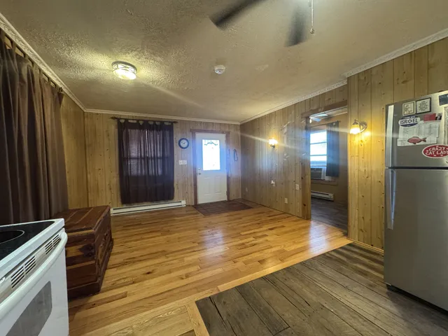 a kitchen with stainless steel appliances granite countertop a stove top oven and refrigerator