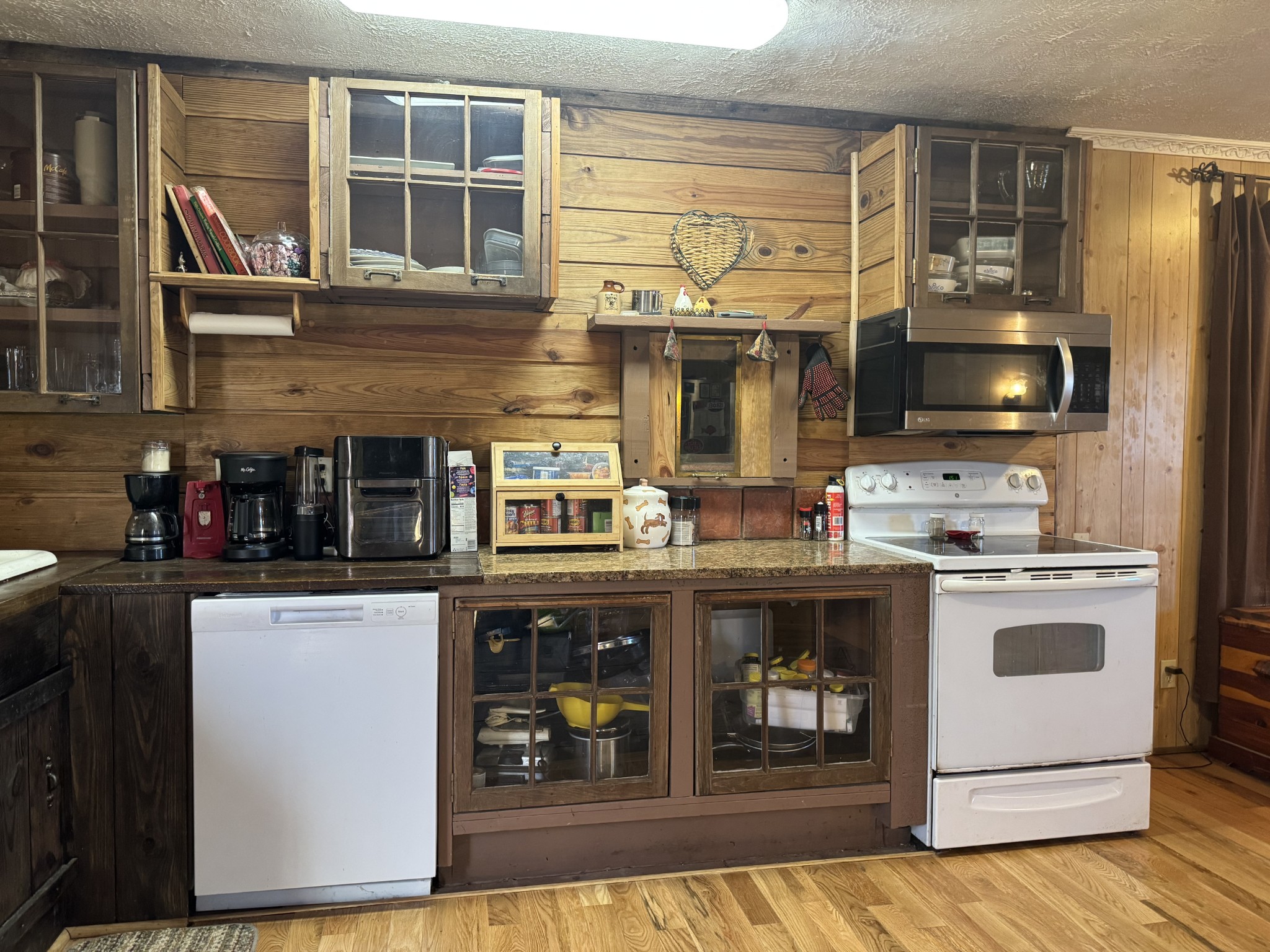 10795 Back Piney Road Bon Aqua, TN 37025 - Photo 17 of 64 a kitchen with stainless steel appliances granite countertop a stove and a microwave